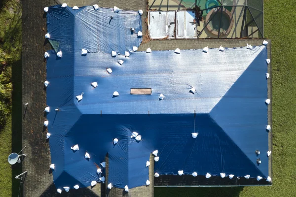 top-view-of-leaking-house-roof-covered-with-protec-2026-01-06-09-59-09-utc top-view-of-leaking-house-roof-covered-with-protec-2026-01-06-09-59-09-utc